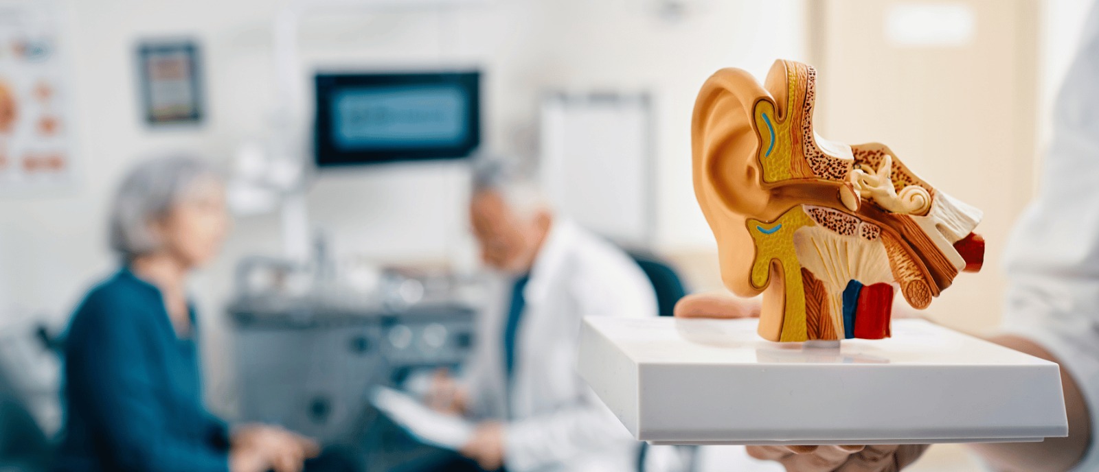 Woman smiling while wearing modern hearing aids, enjoying music and emotional connection through sound